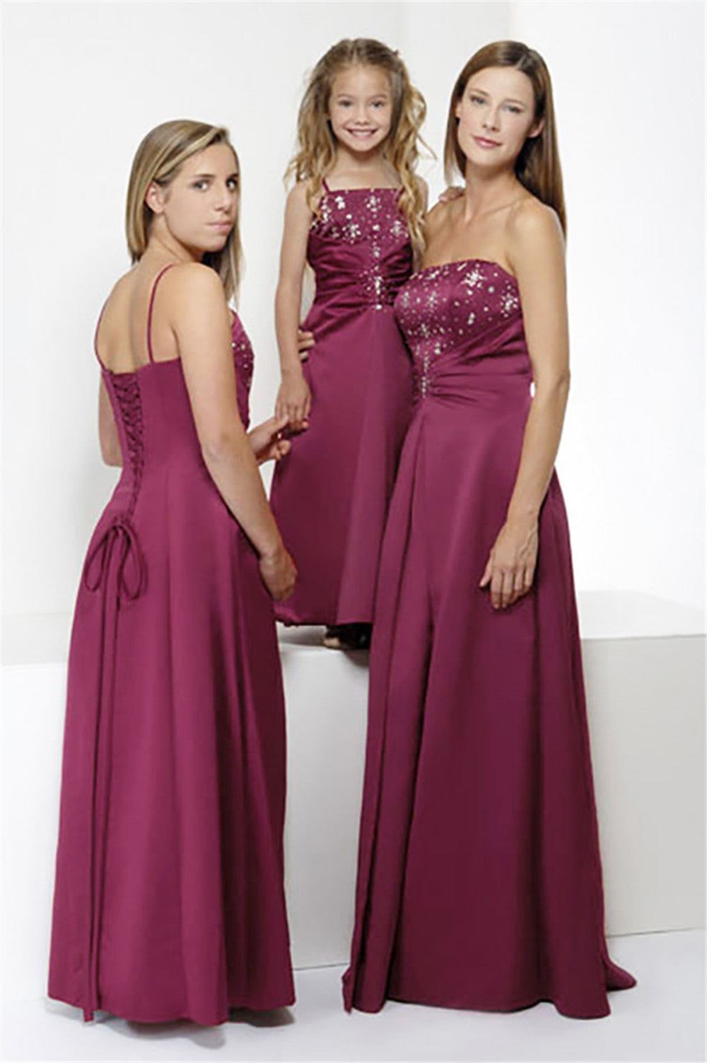 Burgundy full-length bridesmaid dress style 0154 featuring hand-beaded details and lace-up back, displayed on adult, teen, and child models for wedding parties.