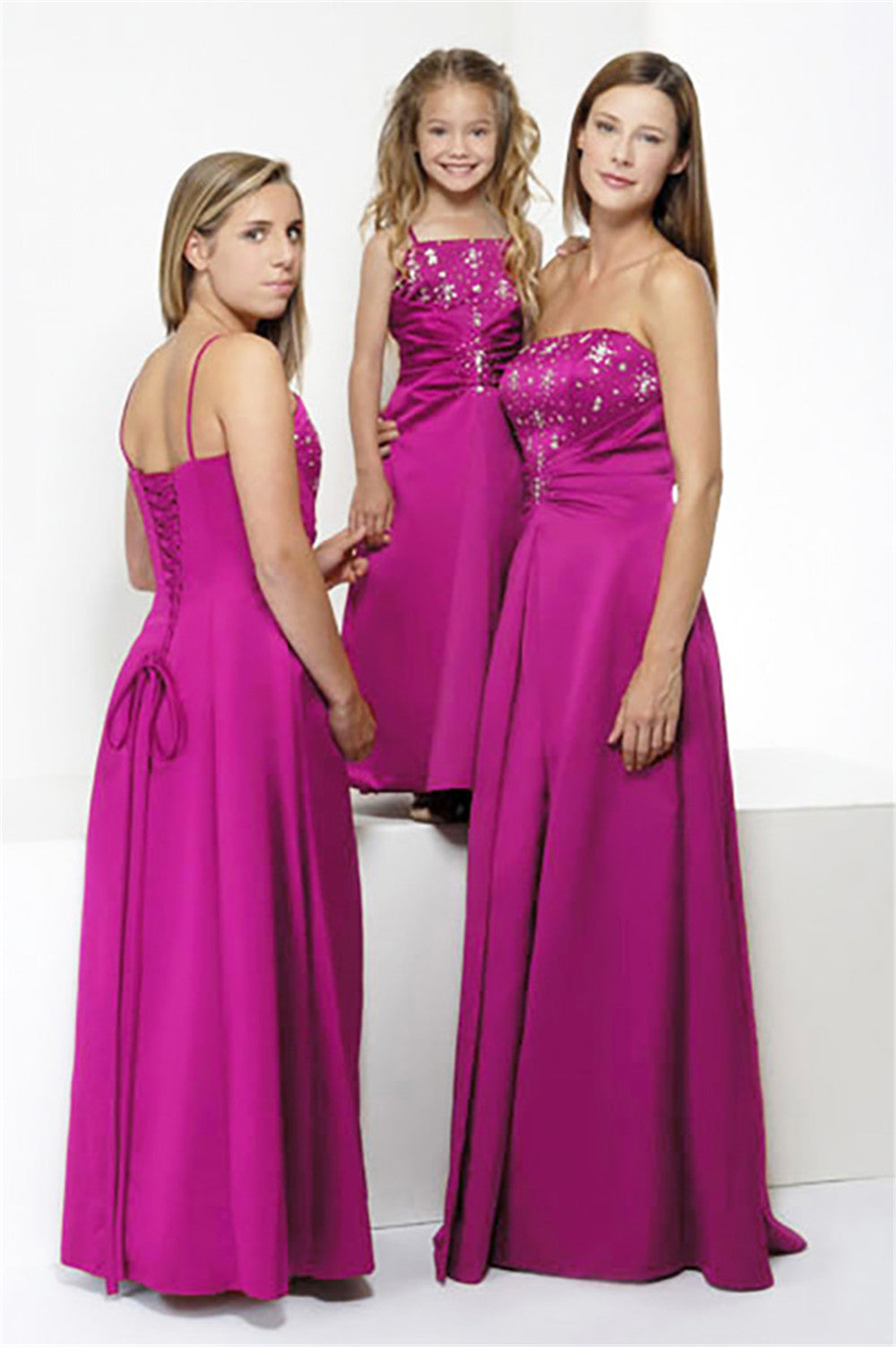 Pink full-length bridesmaid dress style 0154 with ruched bodice and built-in bra, shown on adult, teen, and child for spring and summer weddings.