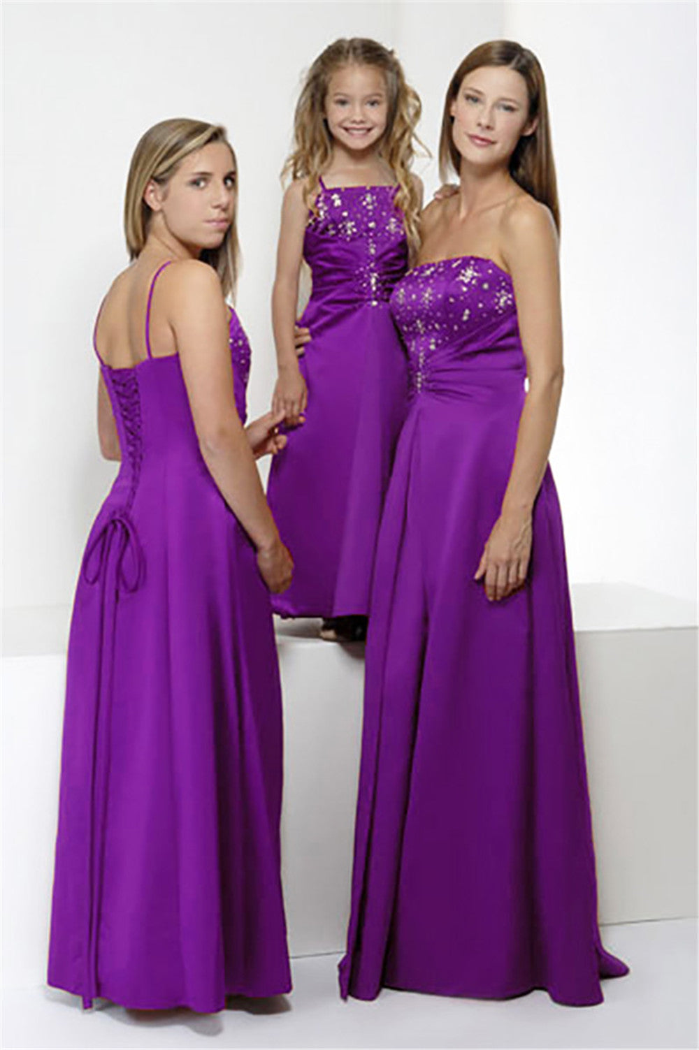 Purple full-length bridesmaid dress style 0154 with A-line silhouette and corset bodice, modeled by adult, teen, and child for formal events.